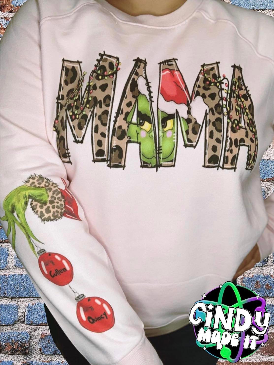 Mean One/Grin Face MAMA Christmas Sweatshirt with custom names on sleeve